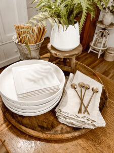 Neutral Kitchen Decor - white dishes, candles, spoons, greenery
