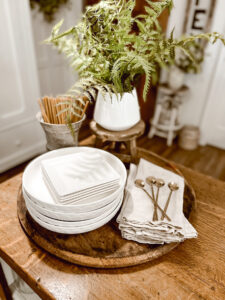 Neutral Kitchen Decor - white dishes, candles, spoons, greenery