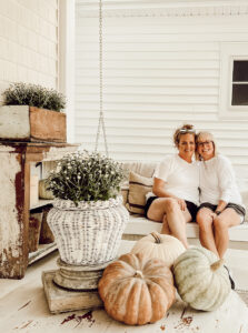 Neutral fall porch decor, porch swing, woods and whites - Deb and Danelle