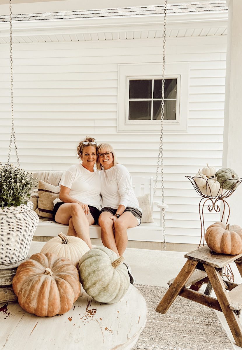 Neutral fall porch decor, porch swing, woods and whites - Deb and Danelle