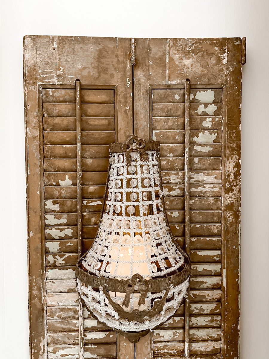 Mirror made from a church window, shutters, sconces