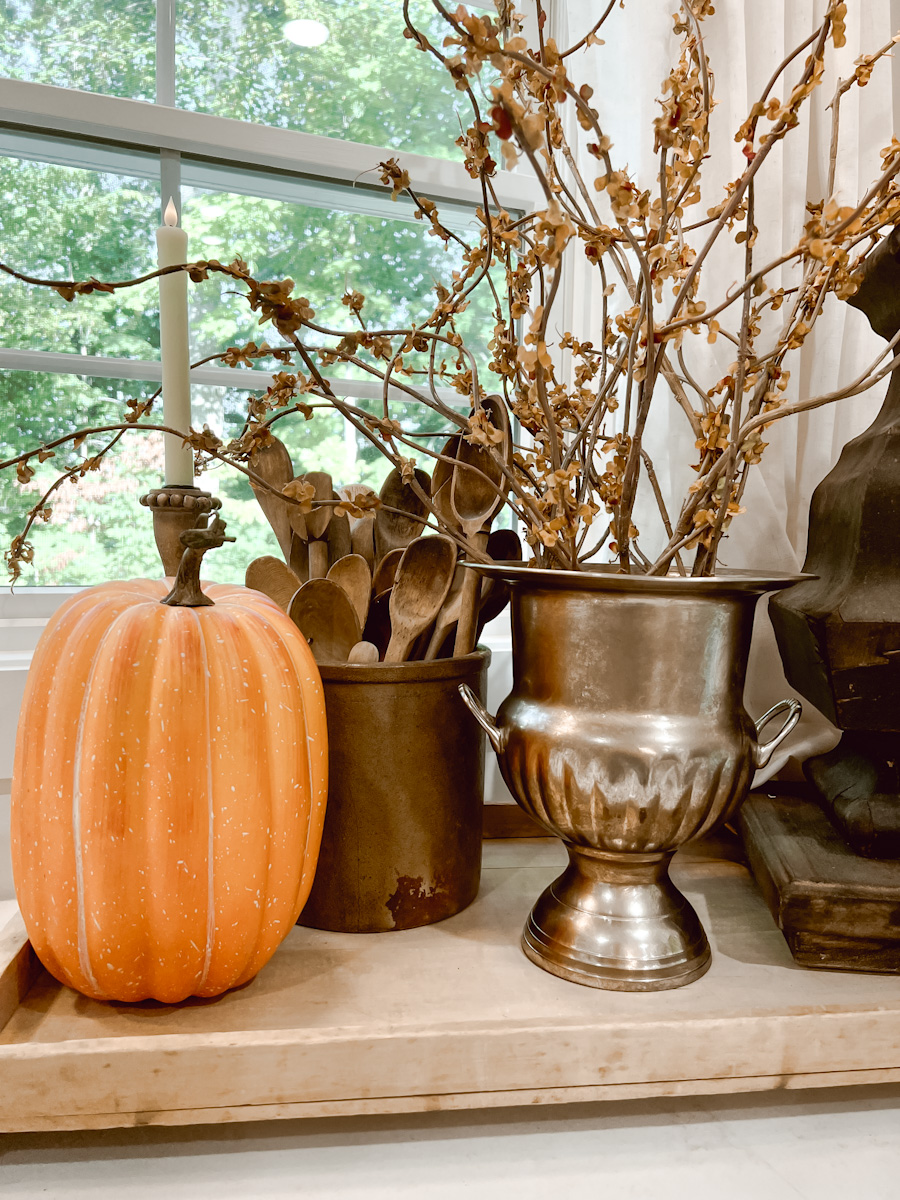 Decorating the Kitchen for Fall using berry stems and pumpkins.