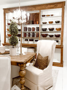 Large Cabinet in Dining Room with brown pottery